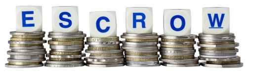 Stacks of coins with the word ESCROW isolated on white