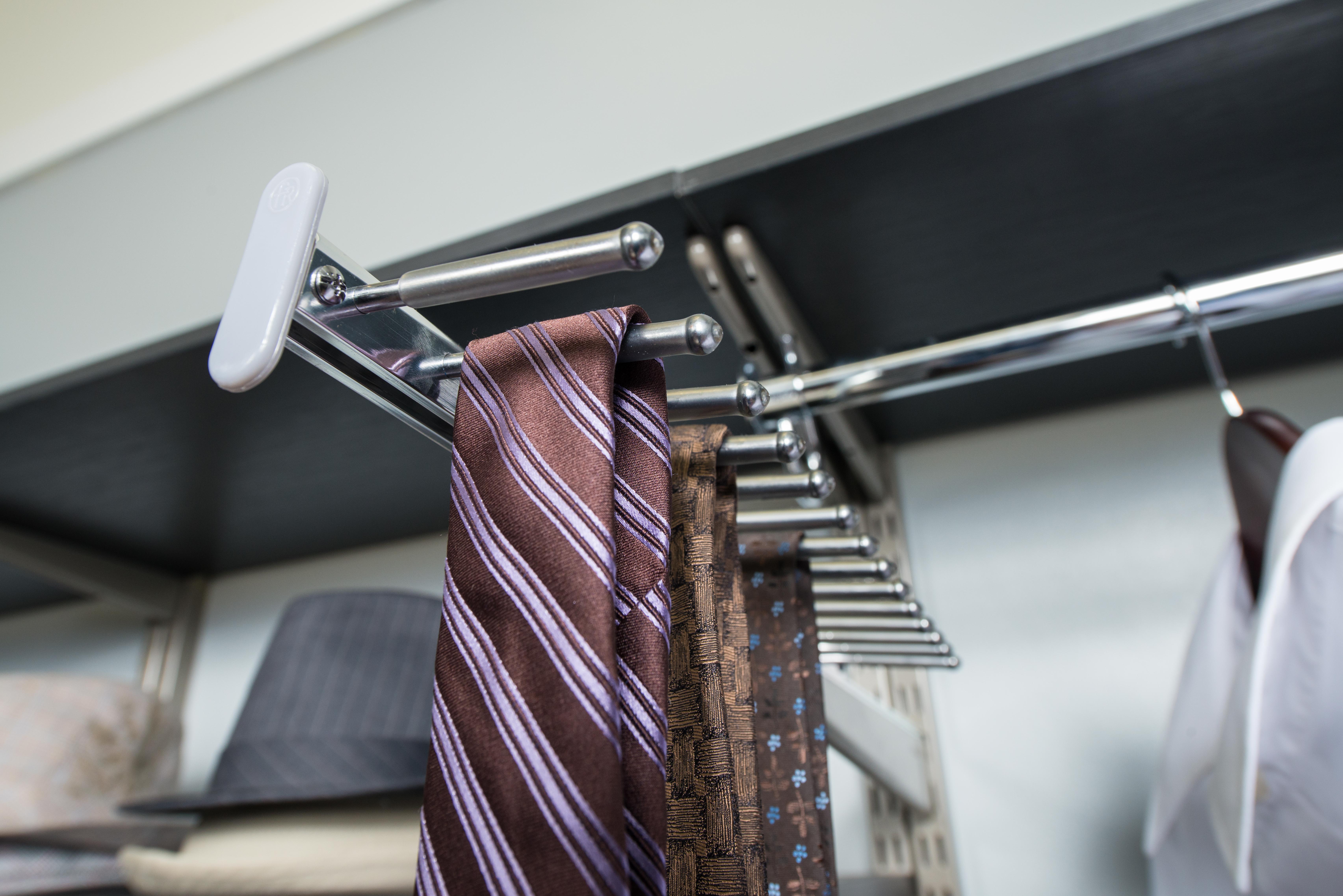 Sliding Tie and Belt Rack with brown ties and neutral background.