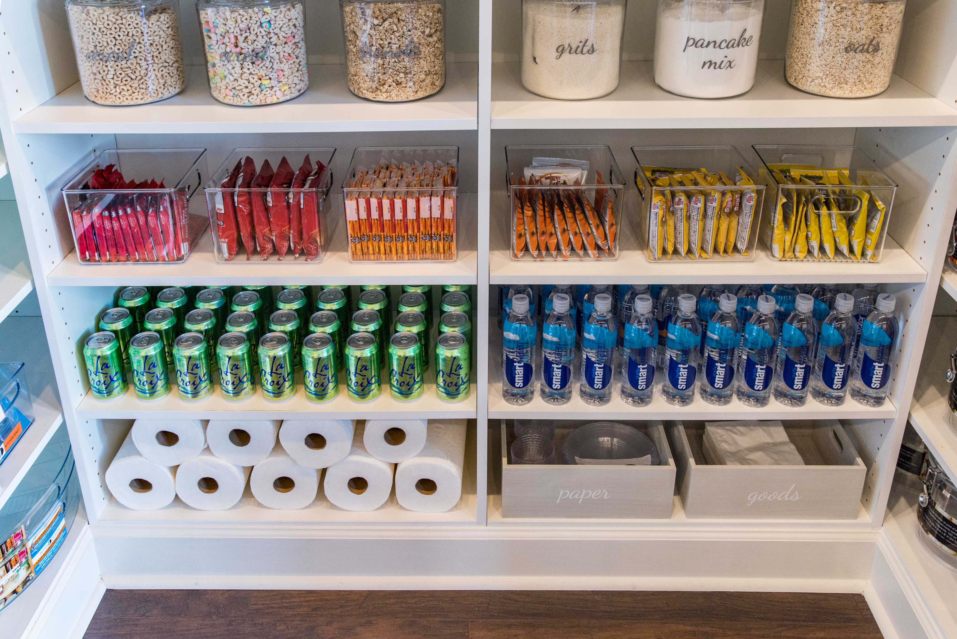 Classica Pantry in White with La Croix seltzers, Smart Water, paper towels, and color coordinated snacks.