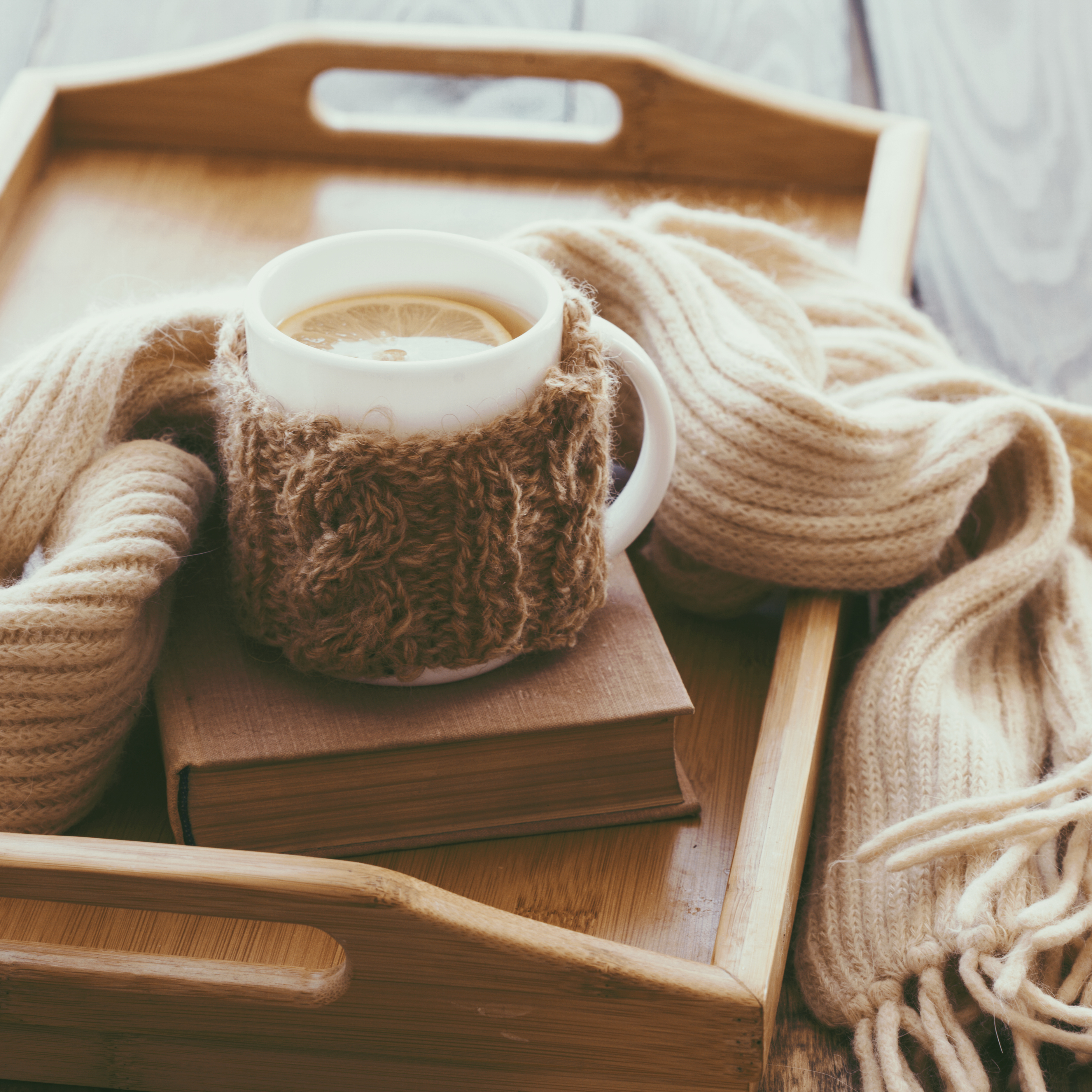 Cup of Tea on a tray and a scarf.