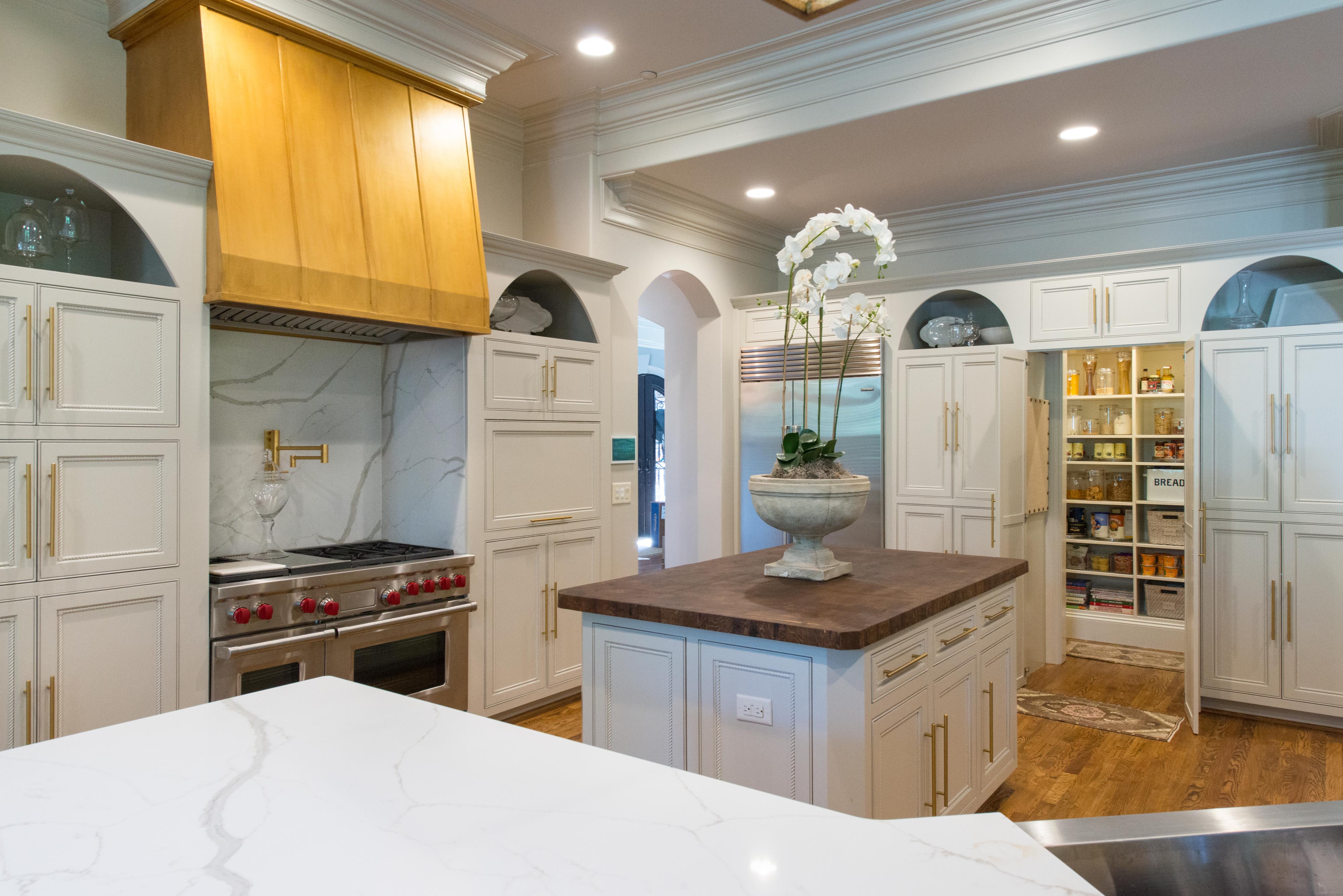 Kitchen in White with pantry and kitchen island.