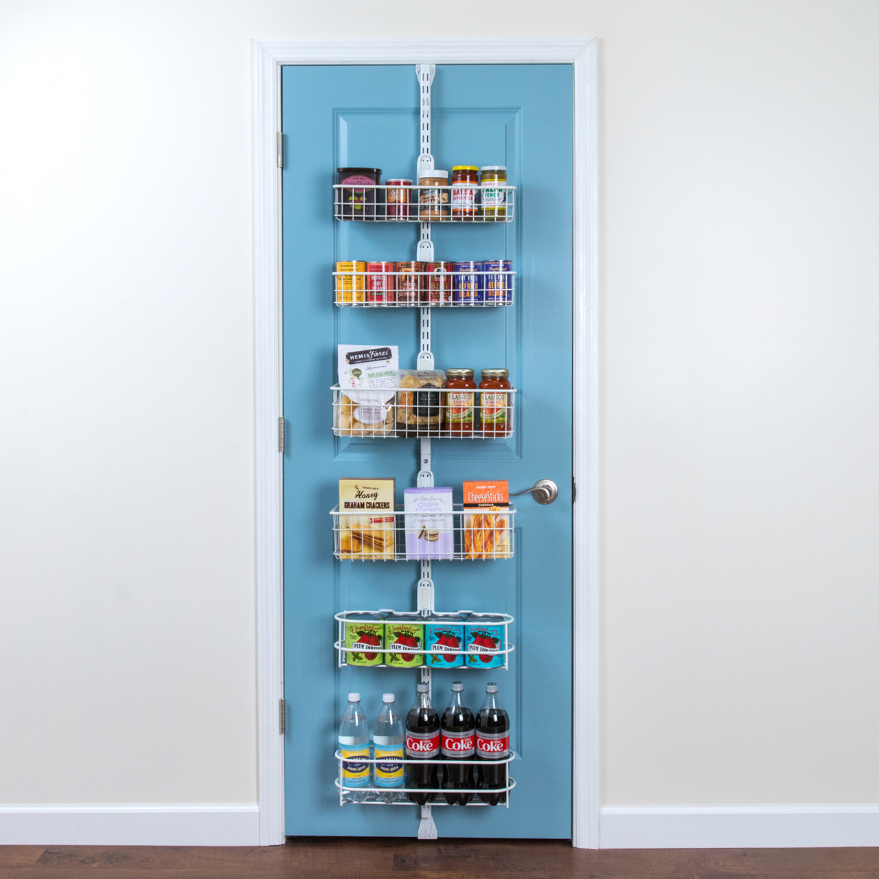 Over The Door Pantry Kit in White with six baskets of dry goods, drinks, and canned goods.