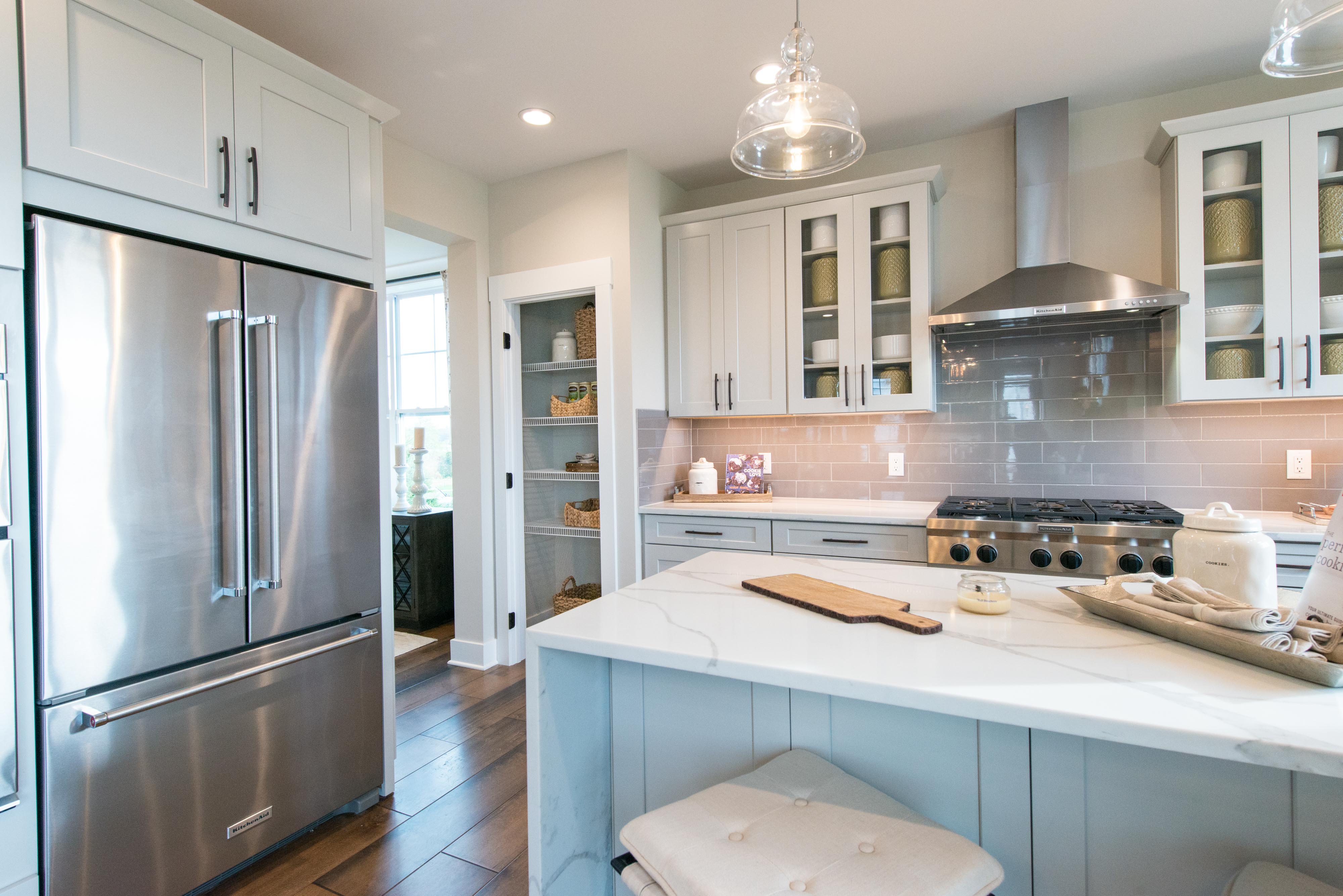 Toll Brothers Home Kitchen with island and pantry.