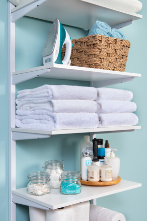 freedomRail Built-in Linen Closet in White with towels and baskets.