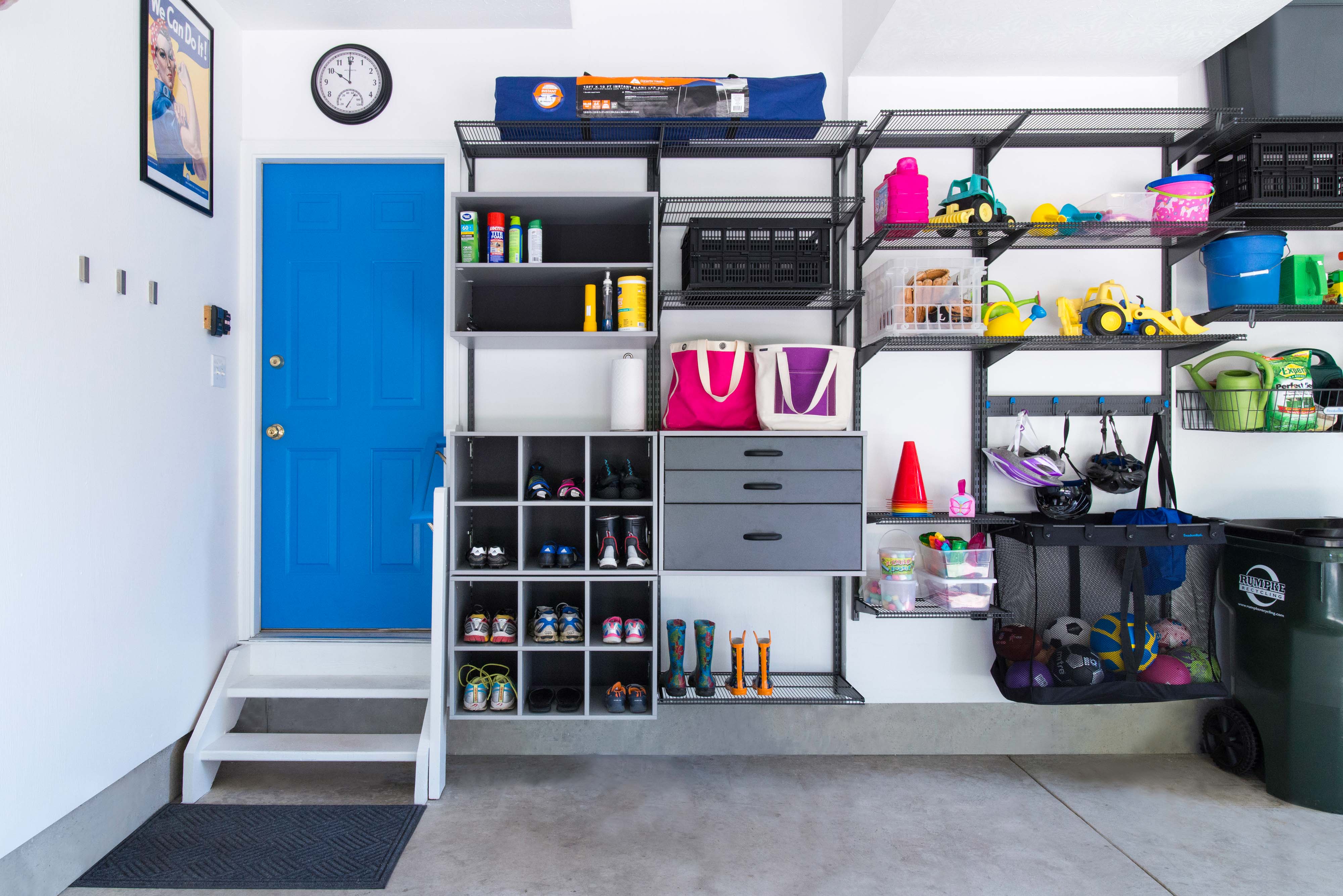 freedomRail Garage Overview with bright blue door, shoe cubbies, and more garage storage shelves.