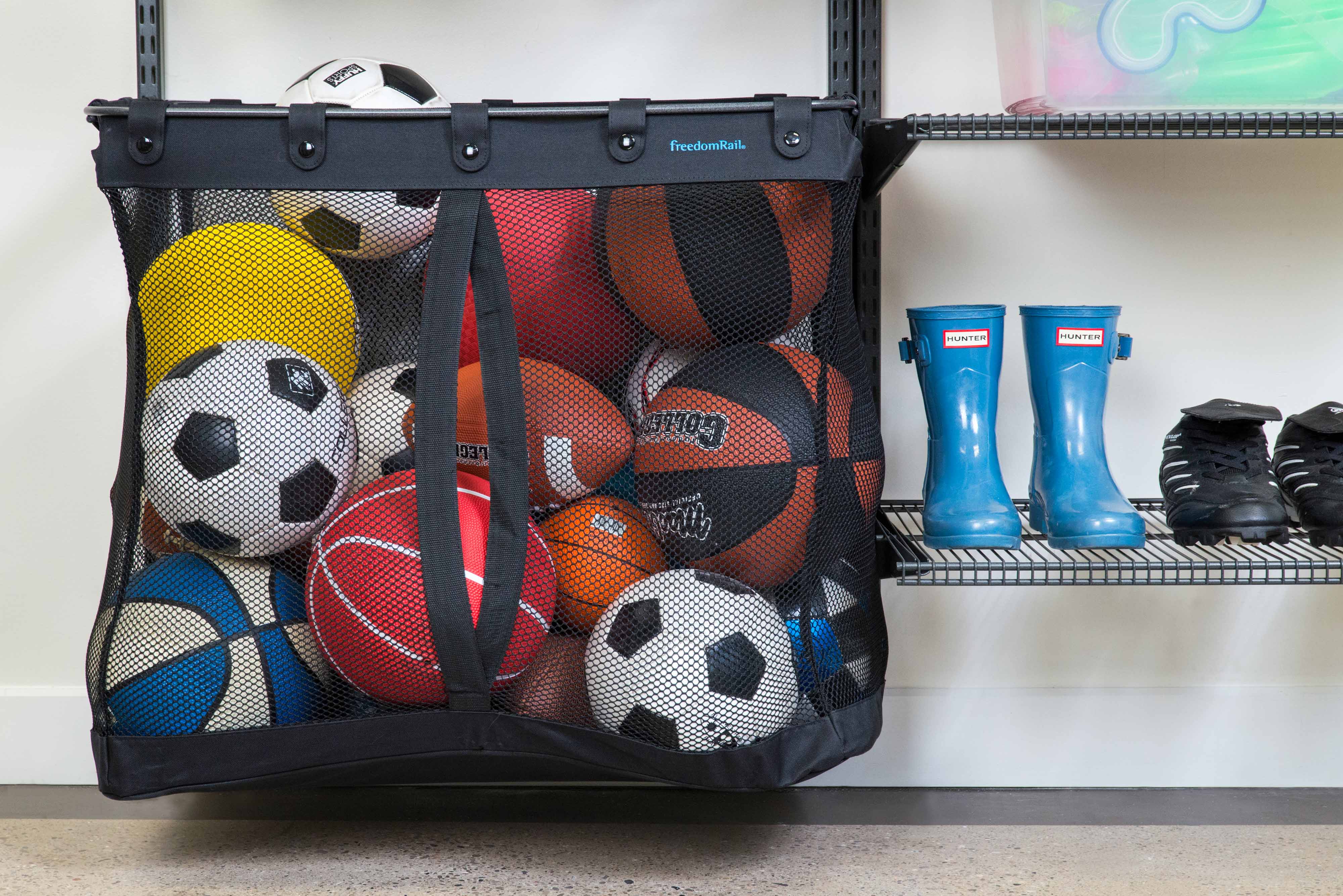 freedomRail Garage Sports Basket with sports balls, Hunter boots, cleats, and shelving.