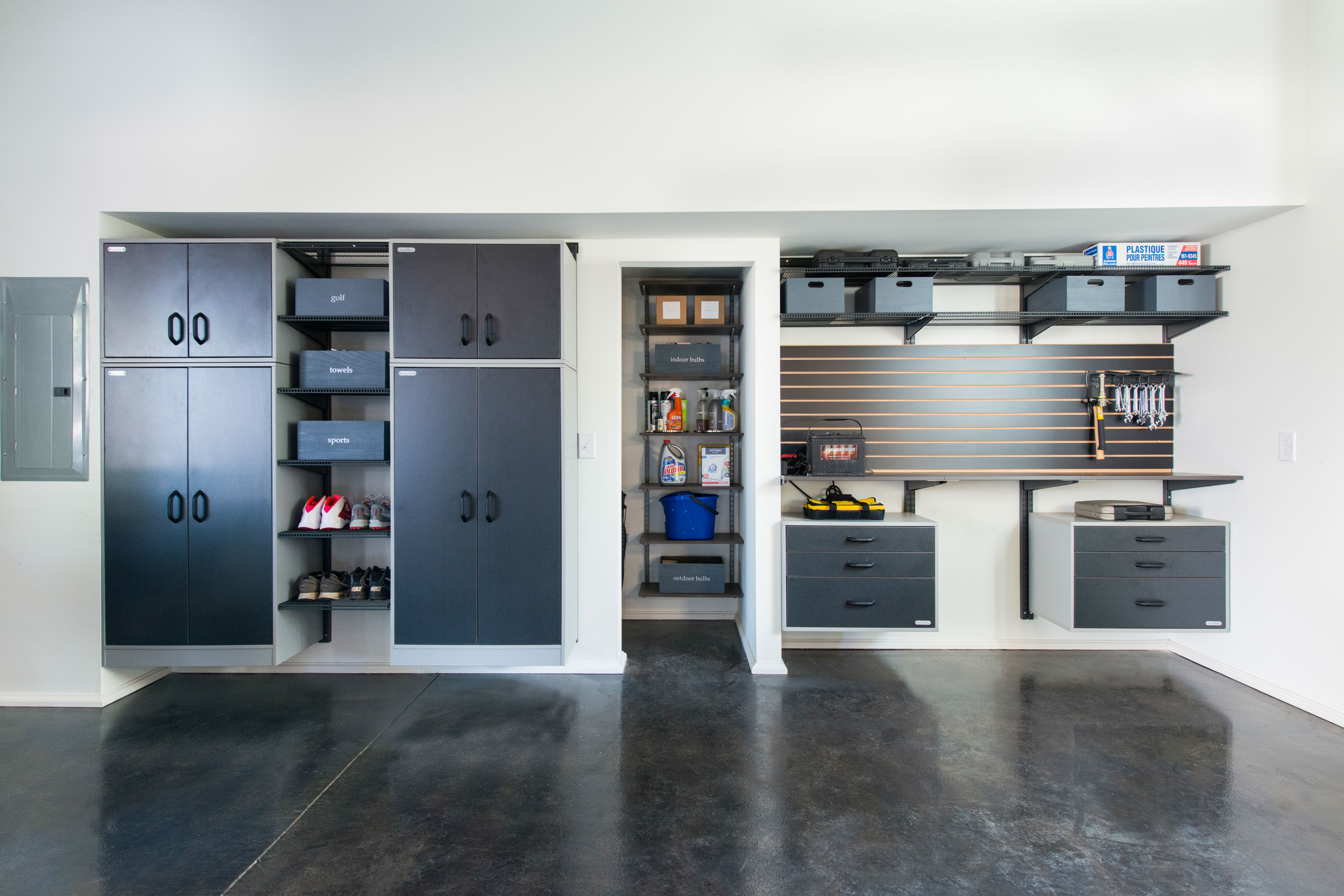 freedomRail Garage with cabinets and drawers with organized garage items and tools.