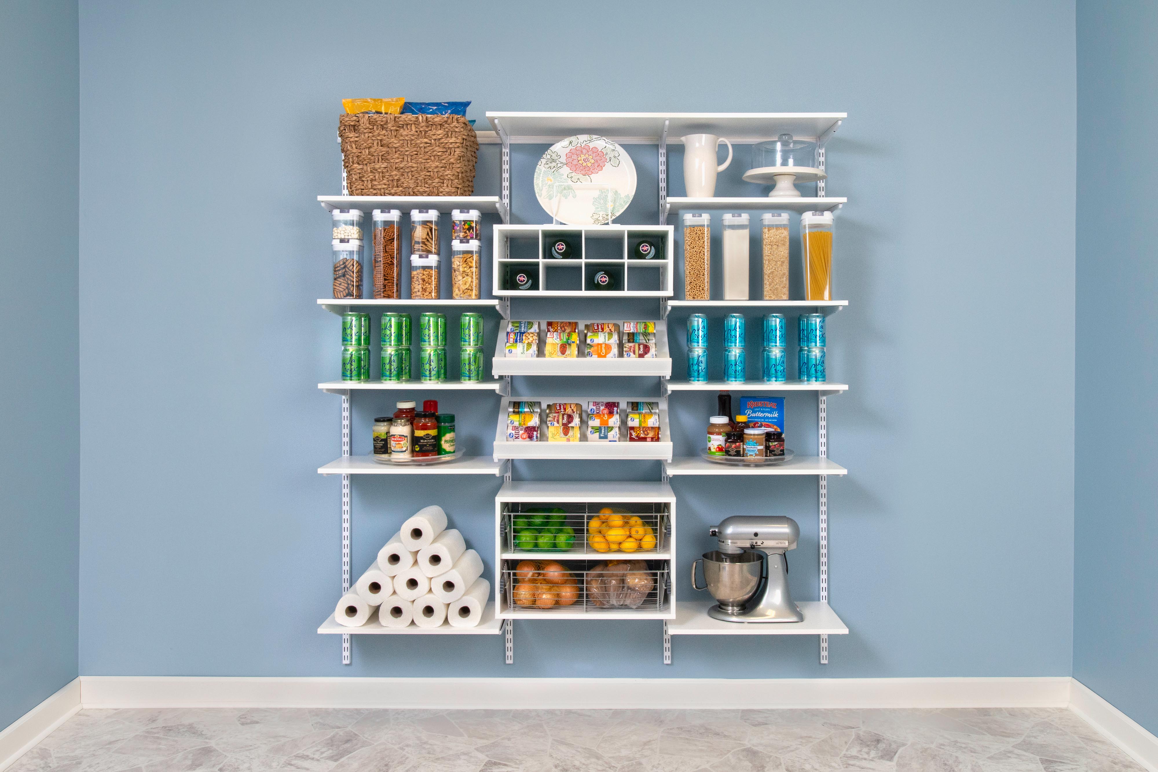 freedomRail Pantry in White with dry goods, paper towels, stand mixer, and drinks. 