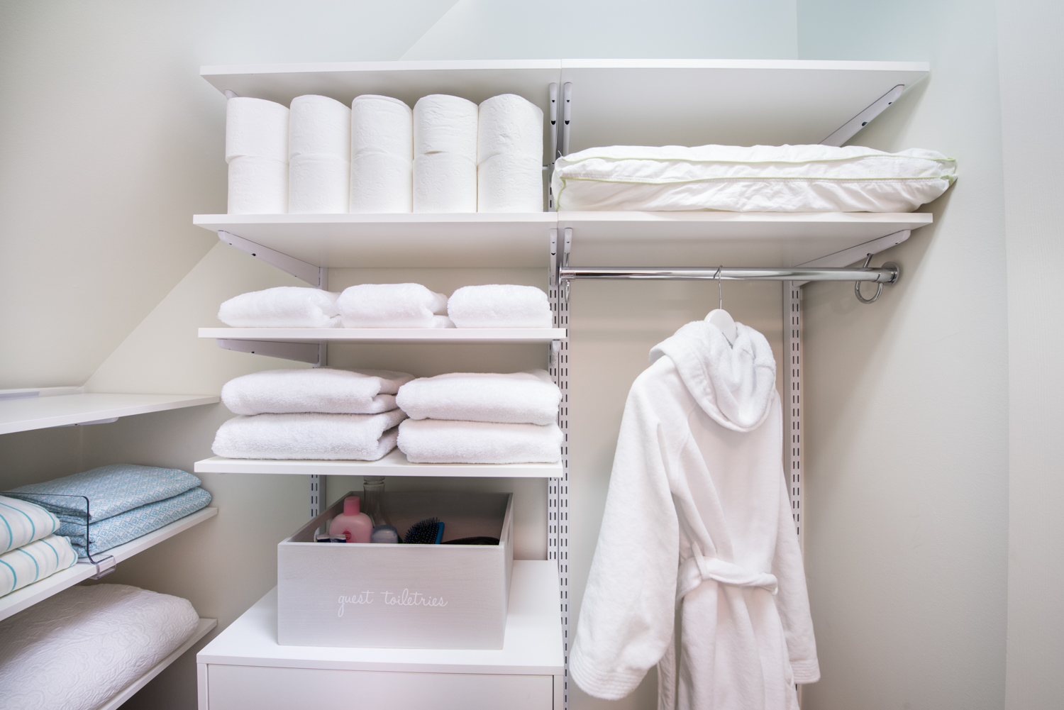 freedomRail Walk-in Closet in White with robe and towels.