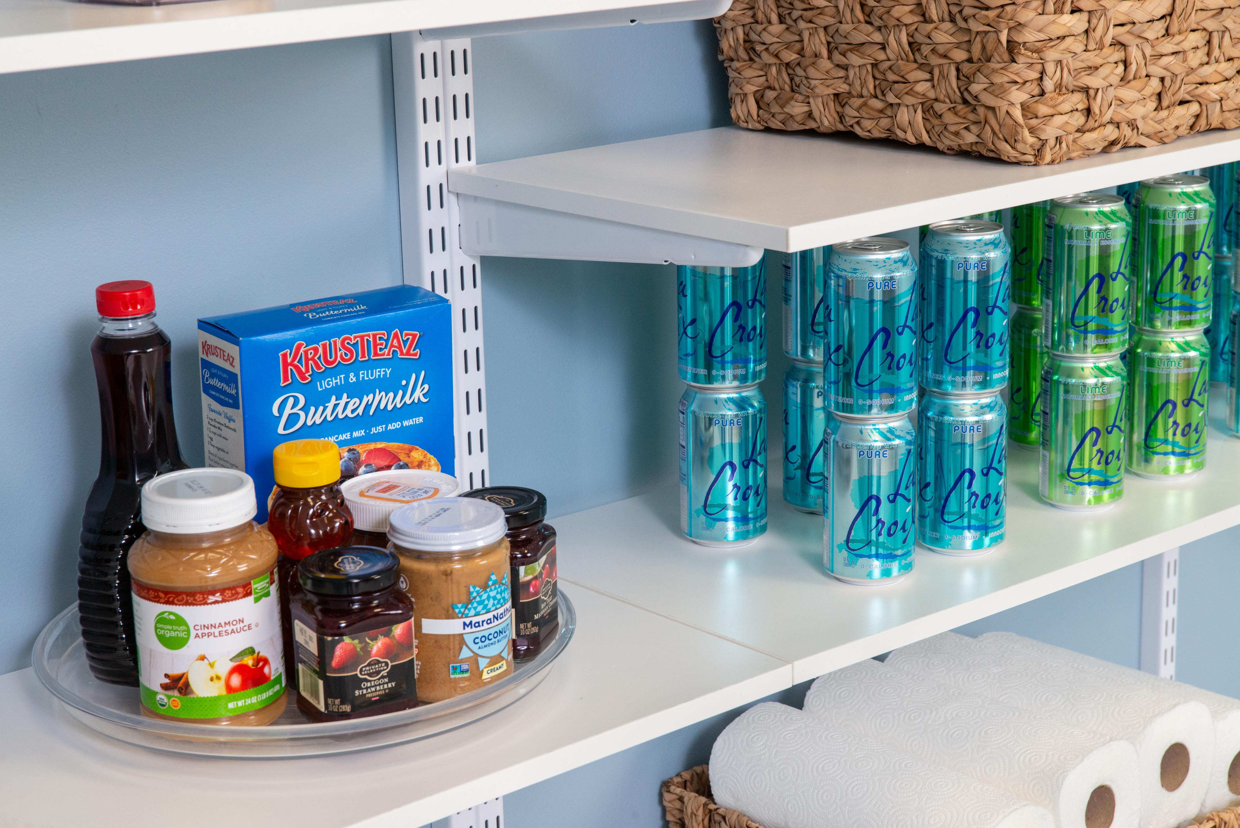 freedomRail White Pantry with seltzers and turntable organizer.