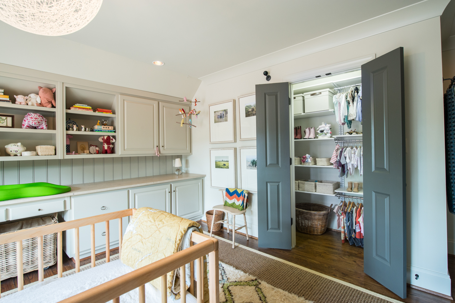 Nursery with Cabinetry and freedomRail reach-in closet in white.