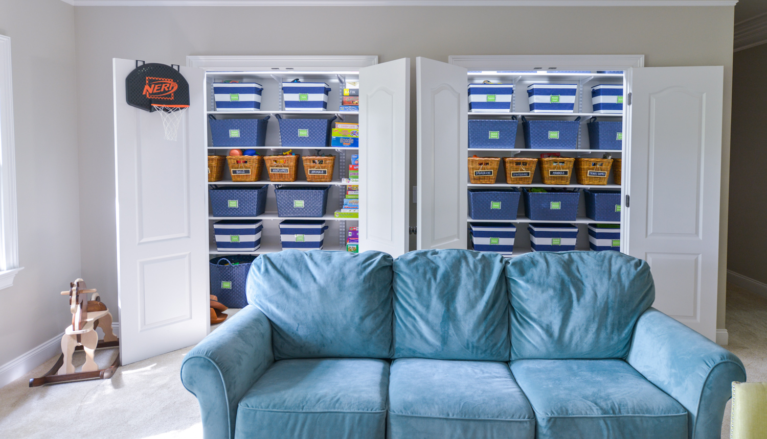 freedomRail Reach-in closet in White with baskets and games.