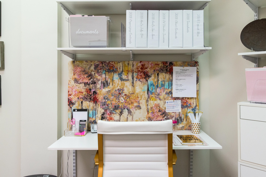 freedomRail office desk in White with binders and art work.